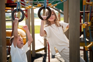 brother-sister-having-fun-outdoors-playground_23-2149587778